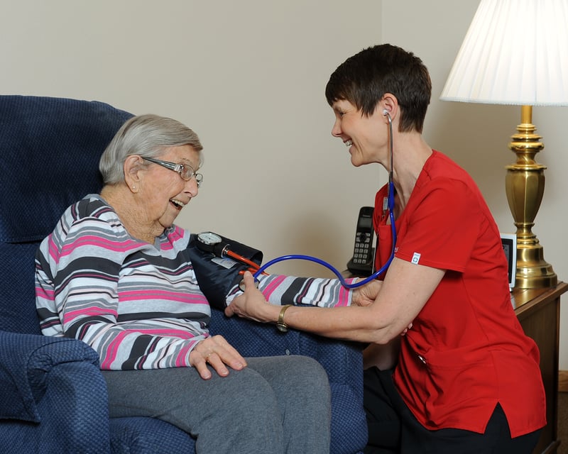 A nurse attending to a senior citizen