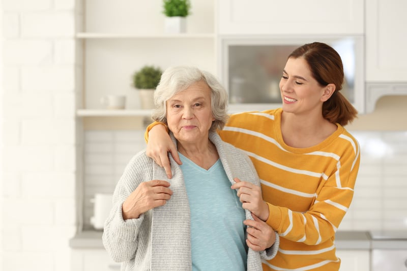 Woman taking care of senior mother in kitchen